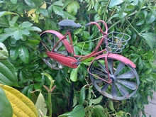 Tiny metal red bike statue