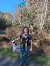 Nick with Wiliiam and a bag of garbage he picked up along the road